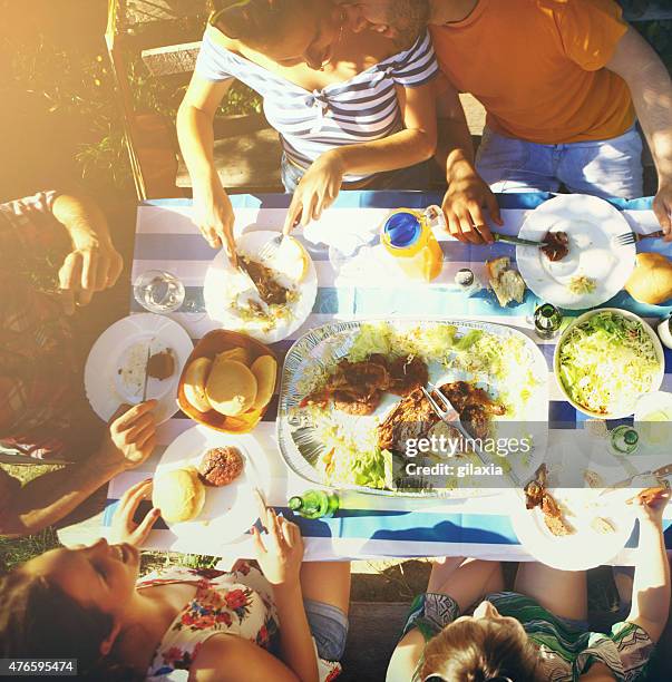 group of people having lunch outdoors. - serving dish stock pictures, royalty-free photos & images