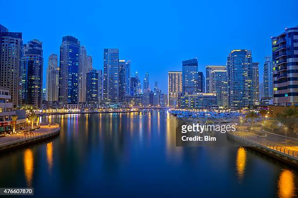 dubai marina skyline illuminated at dusk, united arab emirates - dubai marina stock pictures, royalty-free photos & images