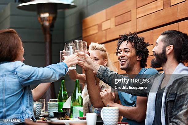 group of friend eating outdoors - toost stockfoto's en -beelden