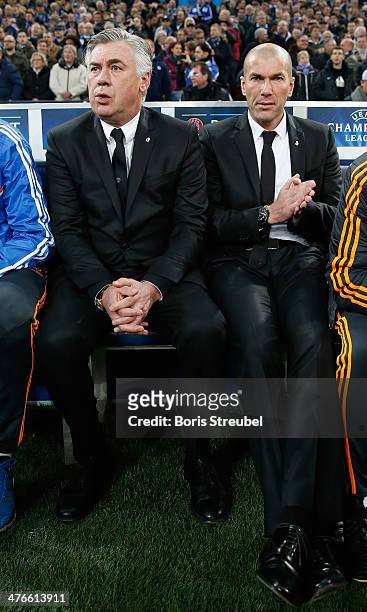 Head coach Carlo Ancelotti and assistant coach Zinedine Zidane of Real Madrid attend the UEFA Champions League Round of 16 first leg match between...