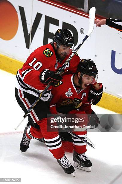 Jonathan Toews celebrates his second period goal with Patrick Sharp of the Chicago Blackhawks against the Tampa Bay Lightning during Game Four of the...