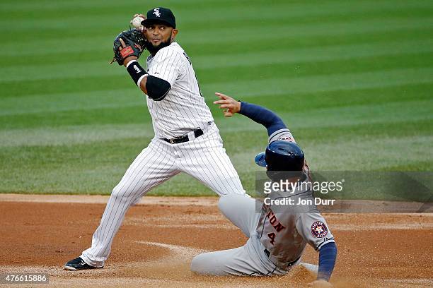 George Springer of the Houston Astros slides into second base to break up the double play by Emilio Bonifacio during the first inning of the Chicago...