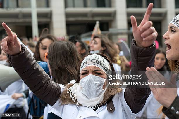 French nursing students shout slogans as they take part in a protest rally against a decision by private clinics to block nursing students from...
