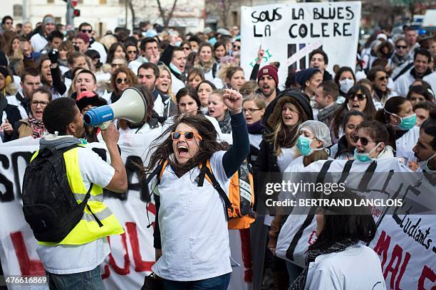 French nursing students shout slogans as they take part in a protest rally against a decision by private clinics to block nursing students from...