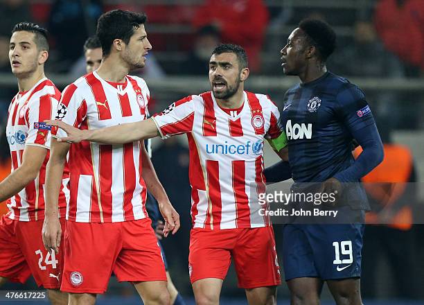 Giannis Maniatis of Olympiacos FC separates Ivan Marcano of Olympiacos FC and Danny Welbeck of Manchester United during the UEFA Champions League...