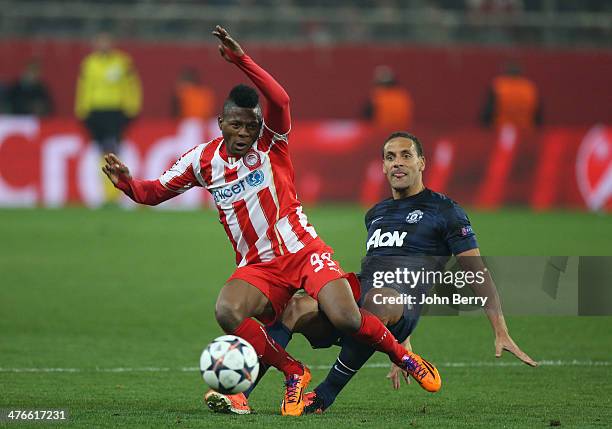 Michael Olaitan of Olympiacos FC and Rio Ferdinand of Manchester United in action during the UEFA Champions League round of 16 between Olympiacos FC...