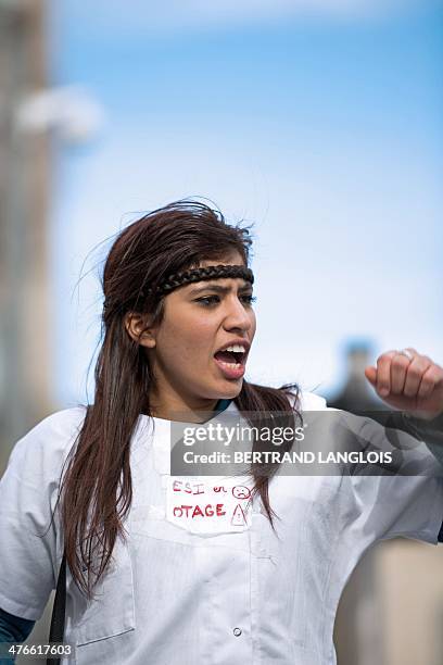 French nursing student shouts slogans as she takes part in a protest rally against a decision by private clinics to block nursing students from...