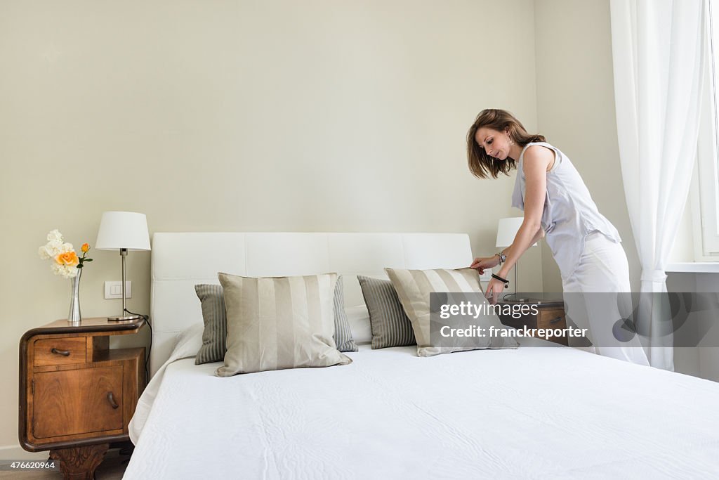 Woman relaxing inside her beautiful bedroom