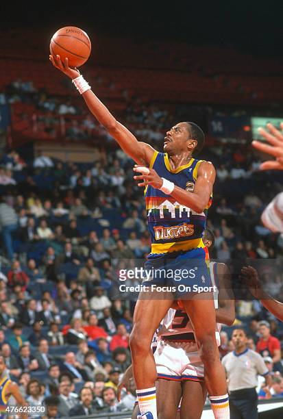 Alex English of the Denver Nuggets lays the ball up against the Washington Bullets during an NBA basketball game circa 1986 at the Capital Centre in...