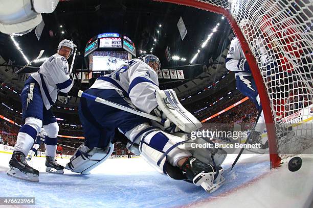 Anton Stralman and Andrei Vasilevskiy of the Tampa Bay Lightning watch a shot by Jonathan Toews of the Chicago Blackhawks cross the line in the...