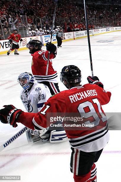 Brandon Saad celebrates with Brad Richards of the Chicago Blackhawks after scoring a goal in the third period against the Tampa Bay Lightning during...