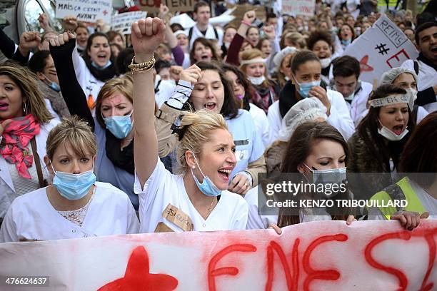 French nursing students shout slogans as they take part in a protest rally against a decision by private clinics to block nursing students from...