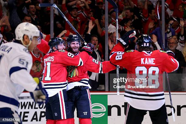 Brandon Saad celebrates with Brad Richards and Patrick Kane of the Chicago Blackhawks after scoring a goal in the third period against the Tampa Bay...
