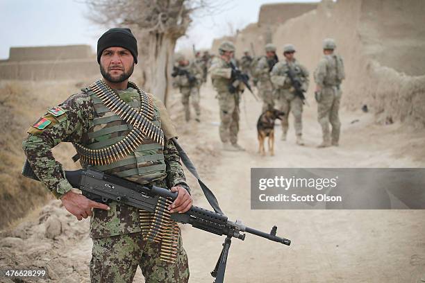 Soldier with the Afghan National Army patrols through a village with soldiers from the U.S. Army's 4th squadron 2d Cavalry Regimentsit on March 4,...