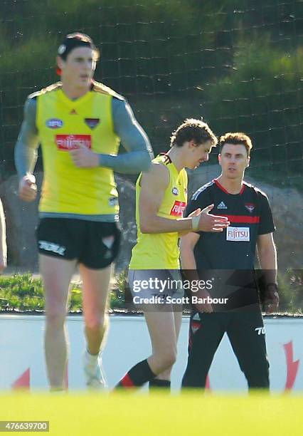 Bombers goal-kicking coach Matthew Lloyd speaks with Jake Carlisle and Joe Daniher during an Essendon Bombers AFL training session at True Value...