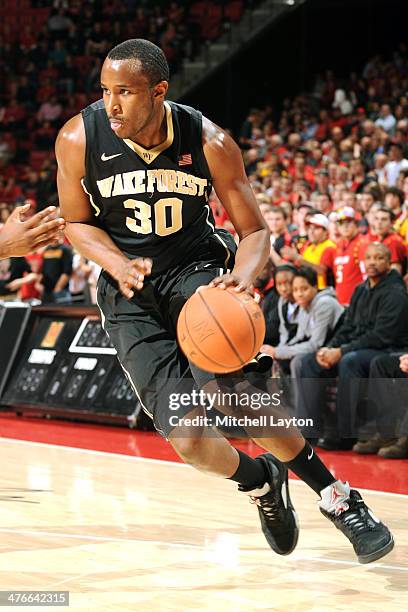 Travis McKie of the Wake Forest Demon Deacons dribbles the ball during a college basketball game against the Maryland Terrapins on February 18, 2014...