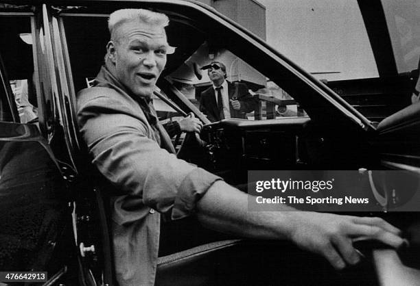 All-American linebacker Brian Bosworth gets into a car at Seattle-Tacoma International Airport after arriving to sign the largest ever contract for a...