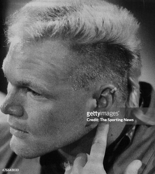 1987All-American linebacker Brian Bosworth scratches behind his ear during his introduction press conference to Seattle media 8/14, drawing attention...