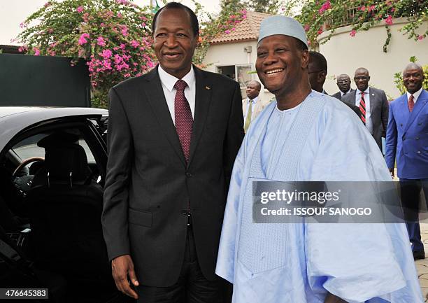 Burkina Faso president Blaise Compaore poses with Ivory Coast president Alassane Ouattara on March 4, 2014 at the president's residence in Abidjan....