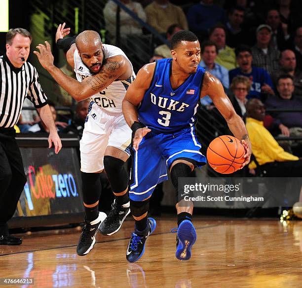 Tyler Thornton of the Duke Blue Devils drives against Trae Golden of the Georgia Tech Yellow Jackets at McCamish Pavilion on February 18, 2014 in...