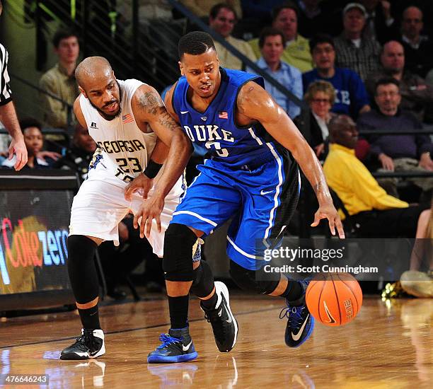 Tyler Thornton of the Duke Blue Devils drives against Trae Golden of the Georgia Tech Yellow Jackets at McCamish Pavilion on February 18, 2014 in...