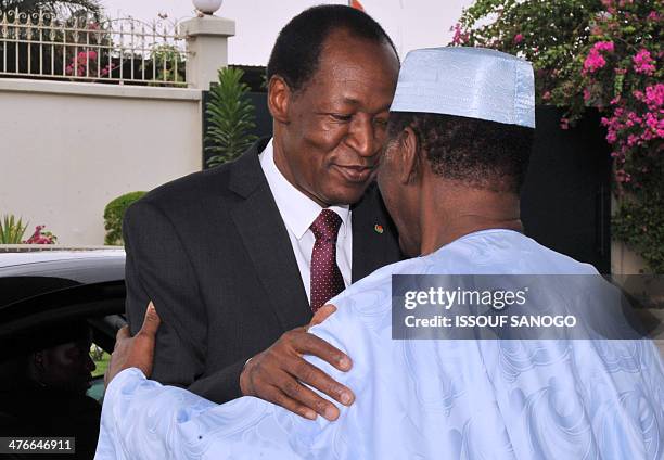 President Alassane Ouattara of Ivory Coast welcomes his Burkina Faso's counterpart Blaise Compaore on March 4, 2014 at the president Ouattara...