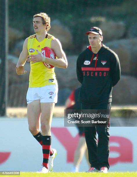 Bombers goal-kicking coach Matthew Lloyd speaks with Joe Daniher during an Essendon Bombers AFL training session at True Value Solar Centre on June...