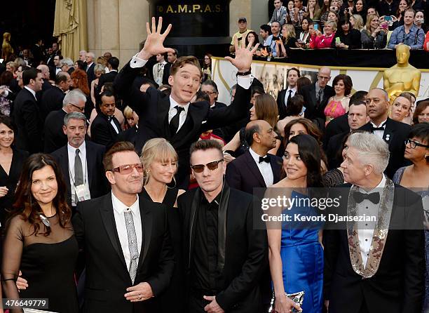 March 02: Actor Benedict Cumberbatch photo bombs the group photo of musicians Bono, Larry Mullen, Jr. And Adam Clayton of U2 as they arrive for the...