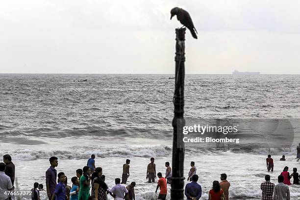 Visitors relax in the surf at Kovalam beach in Kovalam, Kerala, India, on Sunday, May 31, 2015. Prime Minister Narendra Modi is counting on a revival...