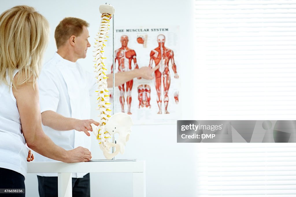 Chiropractor Explains Patient Using Chart And Model High-Res Stock ...
