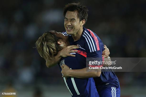 Shinji Okazaki of Japan celebrates scoring a goal with team mate Takashi Usami during the international friendly match between Japan and Iraq at...