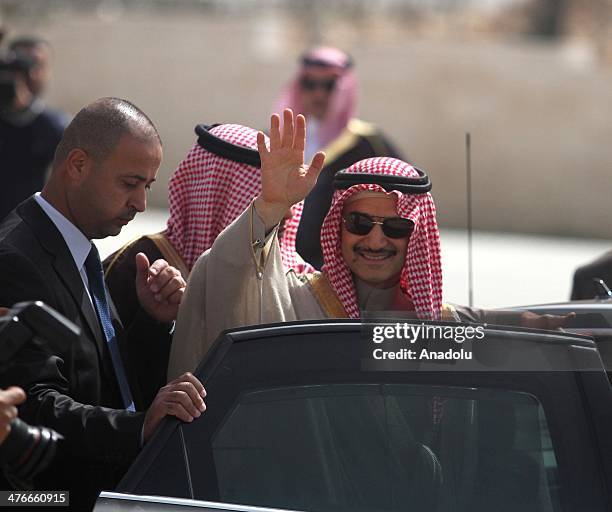 Saudi prince Al-Waleed bin Talal waves during an official visit to the West Bank city of Ramallah on March 4, 2014.