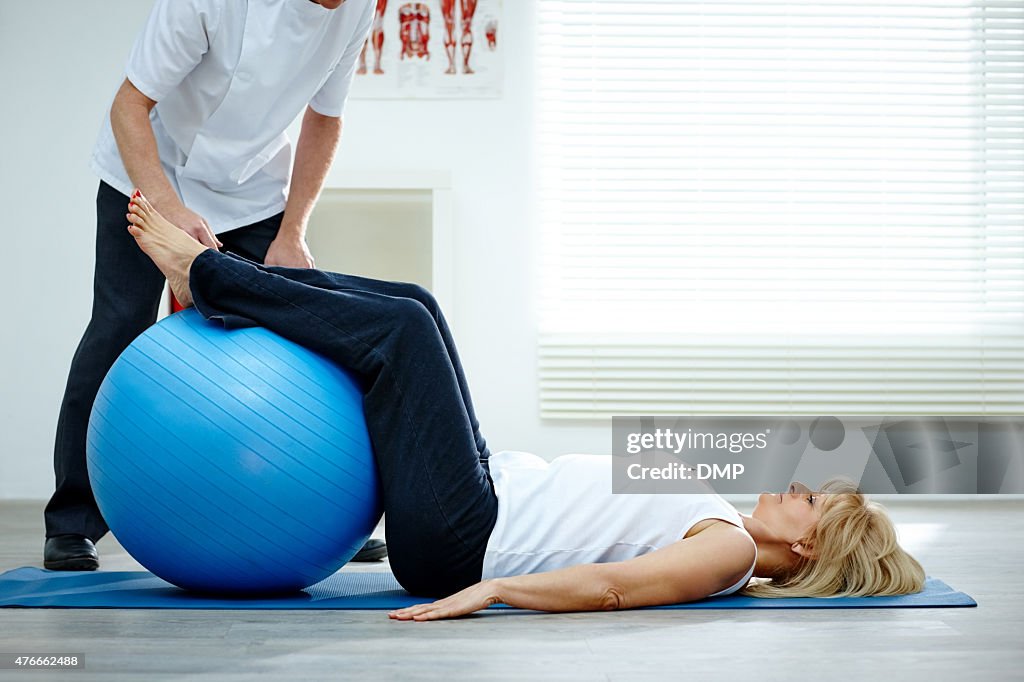 Female patient working with physical therapists pilates exercise