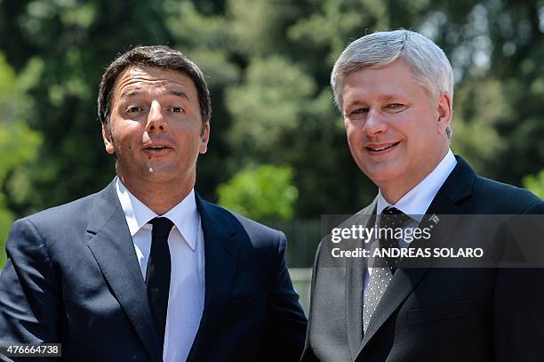 Italian Prime Minister Matteo Renzi greets his Canadian counterpart Stephen Harper before their meeting at Villa Pamphili in Rome on June 11, 2015 ....