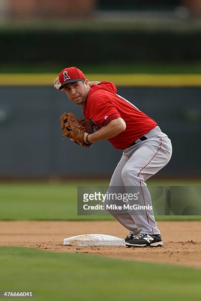 John McDonald of the Los Angeles Angels runs a infield drill during a workout at Tempe Diablo Stadium practice facility on February 25, 2014 in...