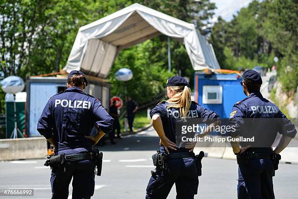Police guard a checkpoint on a road leading to the the Interalpen-Hotel Tirol, venue of the Bilderberg conference, on June 11, 2015 near Telfs,...