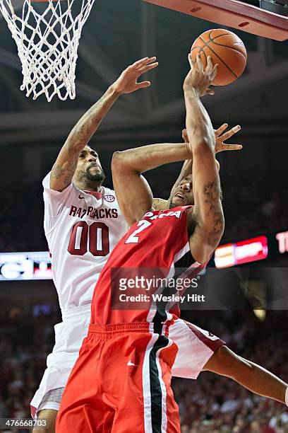 Marcus Thornton of the Georgia Bulldogs goes up for a shot and is fouled by Rashad Madden of the Arkansas Razorbacks at Bud Walton Arena on March 1,...