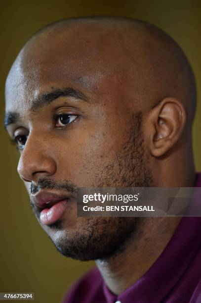 England midfielder Fabian Delph speaks during a press conference following a team training session at London Colney, north of London, on June 11...