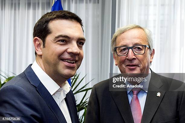 Greece's Prime Minister Alexis Tsipras meets with European Commission President Jean-Claude Juncker during his visit to Brussels to attend to...