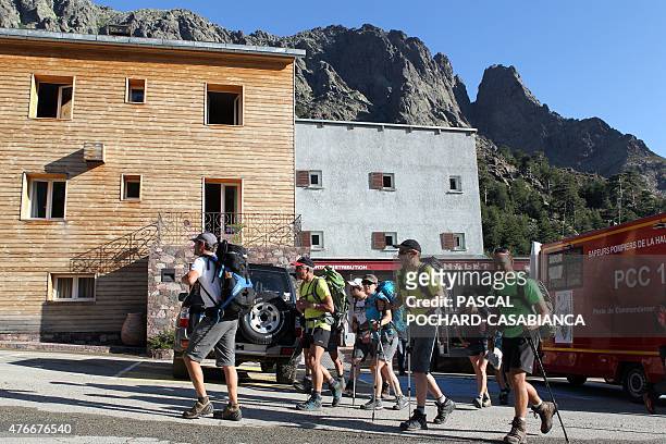 Tourists go for hiking in the GR 20 hiking trail on June 11 near Asco in the French Mediterranean island of Corsica after one part of the trail path...
