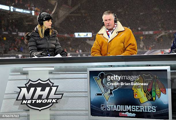 Network hosts Kathryn Tappen and Barry Melrose look on during the 2014 NHL Stadium Series game at Soldier Field on March 1, 2014 in Chicago, Illinois.