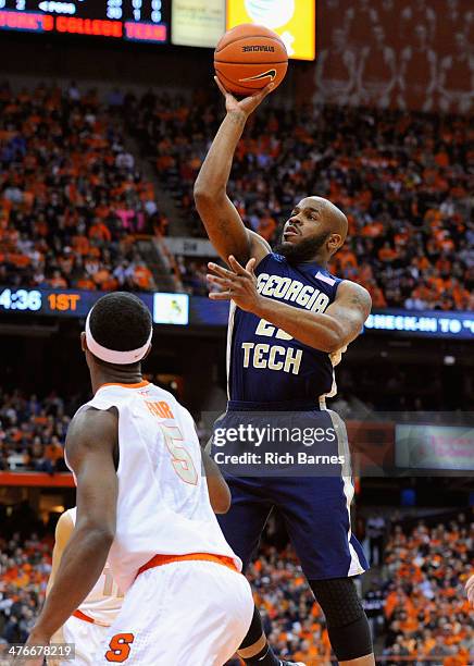 Trae Golden of the Georgia Tech Yellow Jackets takes a shot over C.J. Fair of the Syracuse Orange during the first half at the Carrier Dome on March...