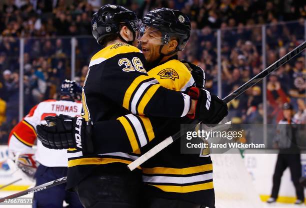 Jarome Iginla of the Boston Bruins celebrates with teammate Jordan Caron following his goal in the first period against the Florida Panthers during...