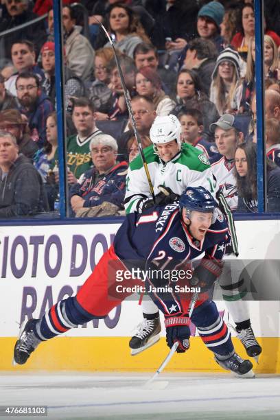 Jamie Benn of the Dallas Stars knocks James Wisniewski of the Columbus Blue Jackets off his feet during the second period on March 4, 2014 at...