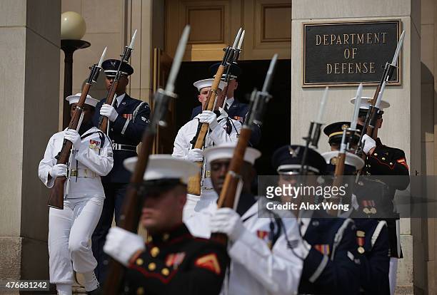 Honor guards march away from the building entrance after an honor cordon June 11, 2015 at the Pentagon in Arlington, Virginia. Secretary Ashton...