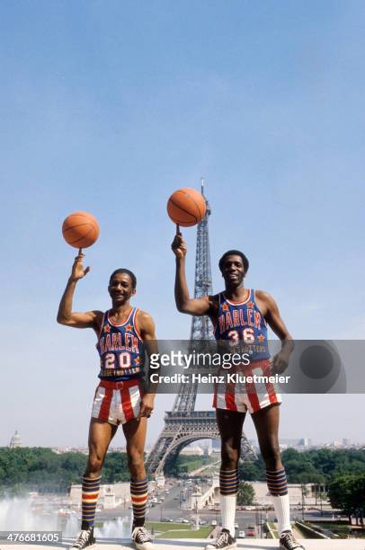 Portrait of Harlem Globetrotters Marques Haynes and Meadowlark Lemon spinning basketballs on fingertips during photo shoot at Jardins du Trocadero....