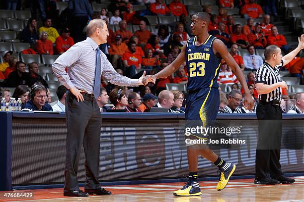 Head coach John Beilein of the Michigan Wolverines congratulates Caris LeVert during the game against the Illinois Fighting Illini at State Farm...