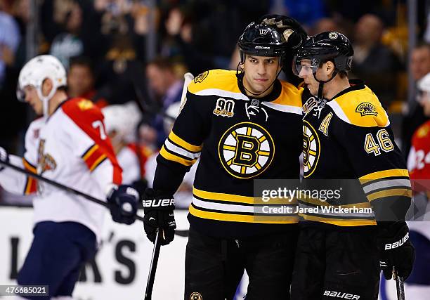 David Krejci of the Boston Bruins celebrates his empty-net goal in the third period to complete the hat trick with teammate Milan Lucic against the...