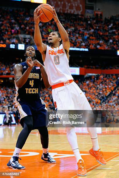 Michael Gbinije of the Syracuse Orange takes a shot in front of Robert Carter, Jr. #4 of the Georgia Tech Yellow Jackets during the second half at...