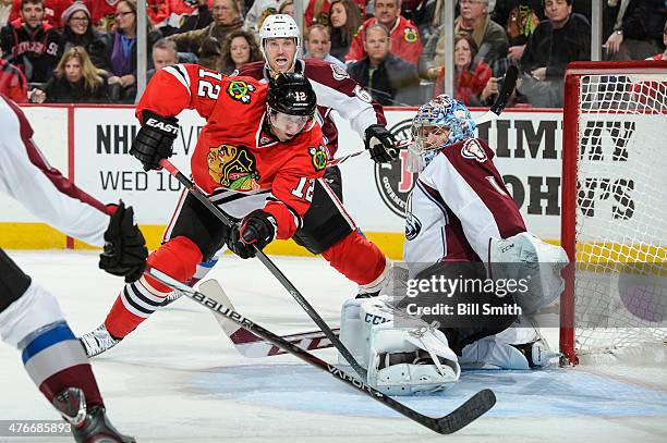 Peter Regin of the Chicago Blackhawks attempts to get the puck past goalie Semyon Varlamov of the Colorado Avalanche during the NHL game on March 04,...